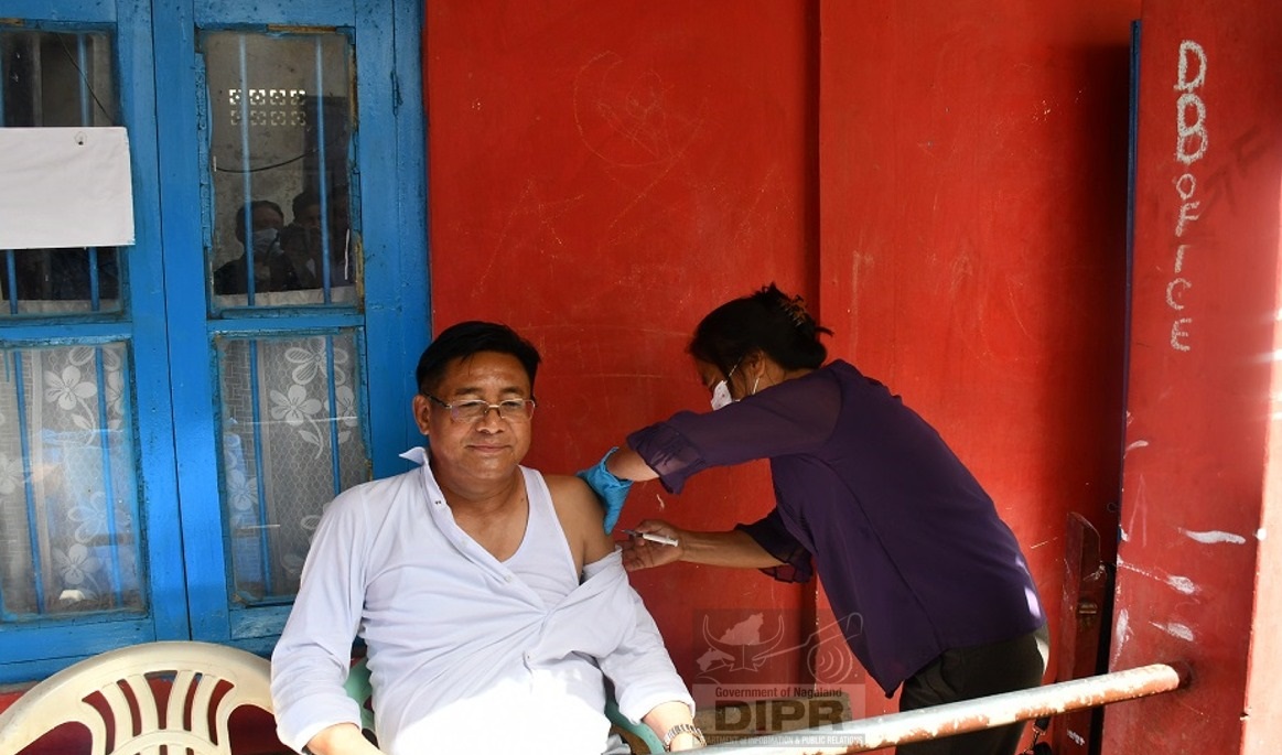 Mhathung Yanthan receiving the booster dose at Wokha