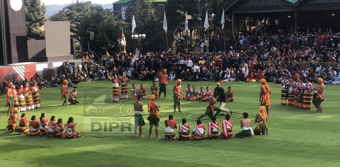Tourist taking part in the indigenous game of Kachari